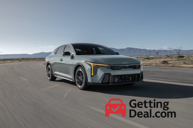 Kia K4 driving on an open desert road under a clear sky, branded with GettingDeal.com logo.
