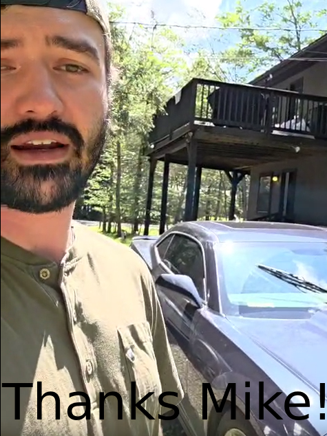 Smiling customer outdoors with newly purchased car, thanking Mike from GetMyCarDeal.com